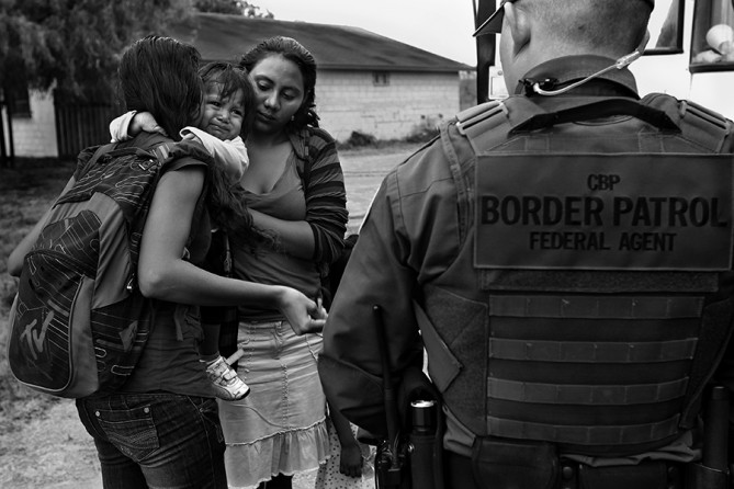 An infant cries as U.S. Border Patrol agents process a group of immigrants in Granjeno, Tx., on June 25, 2014. The city is just north of El Rincon del Diablo, the Devil's Corner, a hotbed of illegal border crossing on the Rio Grande by juvenile and mothers with children immigrants from Central America. (Jerry Lara/San Antonio Express-News)