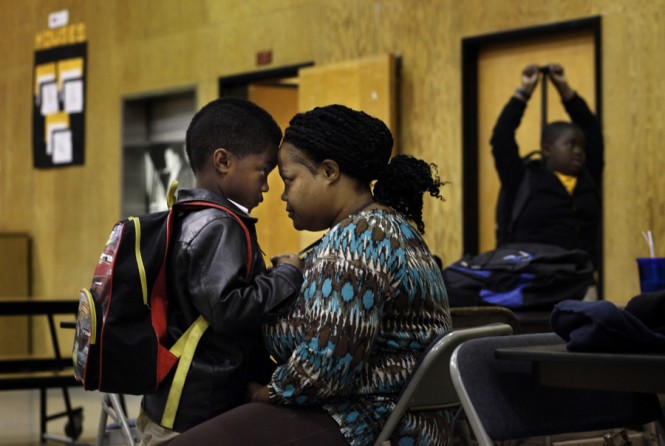 Anastasia Perrilliat tells her son Carton Perrilliat, a kindergarten student, that she loves him and assures him she will to back to pick him up from school. Carton, like many of the students, come from a broken home and he struggles with abandonment issues. (August 25, 2013)