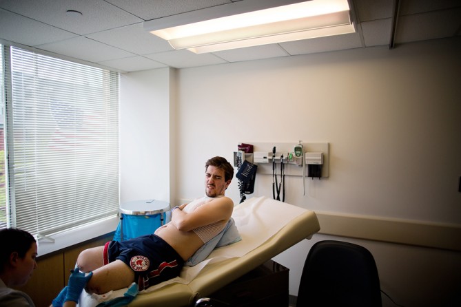 A month after the bombings, Bauman had the sutures removed from what was left of his legs at Boston Medical. Outside, a flag flew at half-staff in honor of the victims. (Josh Haner, The New York Times - May 15, 2013)