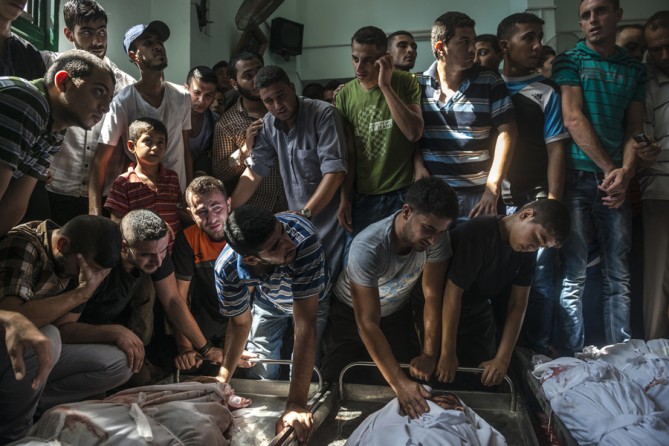 Aug. 4, 2014. Palestinians mourn members of the Nigim family who were killed in an Israeli airstrike in Jabaliya, Gaza. (Sergey Ponomarev for The New York Times)