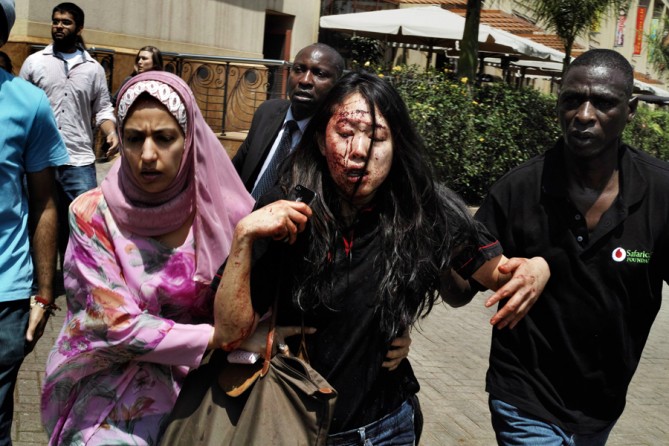 Victims and witnesses of all colors helped each other outside. Hicks is an experienced combat photographer, but said he had never seen anything like this. (Tyler Hicks, The New York Times - September 21, 2013)