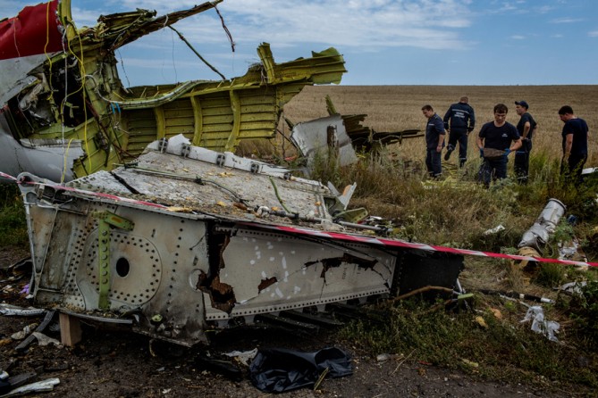 "June 20, 2014. Rescue workers at the crash site of Malaysia Airlines Flight 17 near Grabovo, Ukraine. (Mauricio Lima for The New York Times)
