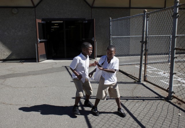 Jeremiah Little and his brother Taric fight on the playground on the last day of the 2012-2013 school year. Because the 100 Black Men Community Charter School let out for the summer later than most Oakland schools, attendance during the last few days of the year dropped and the students became more restive.  (August 25, 2013)