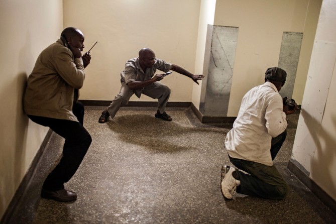 Security forces searched floor by floor for the gunmen. Hicks said the photos could be so honest and true because the subjects 'are not focused on you -- they're just doing their jobs.' (Tyler Hicks, The New York Times - September 21, 2013