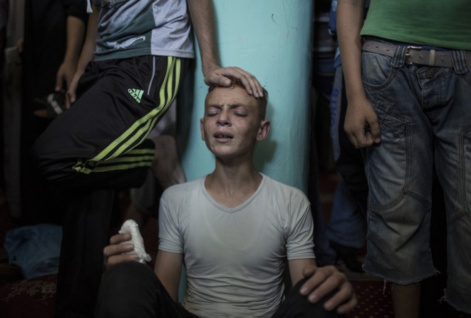 "Aug. 21, 2014. A relative mourns Raed al-Atar, one of three senior Hamas commanders killed in an Israeli military strike, during his funeral in the southern Gaza Strip town of Rafah. (Wissam Nassar for The New York Times)