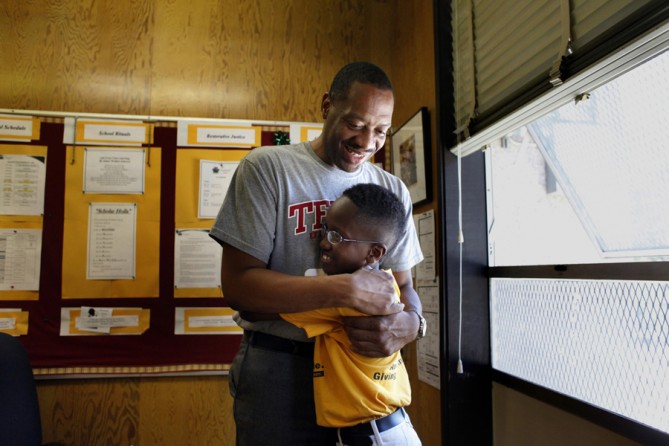 Principal Dr. Stanley Johnson says goodbye to fifth-grader Eresha Woods, on the last day of the 2012-2013 school year. Dr. Johnson admired the boy, because Woods' studiousness and discipline reminded him of himself as a young man. This would likely be the last time they saw each other. (August 25, 2013)