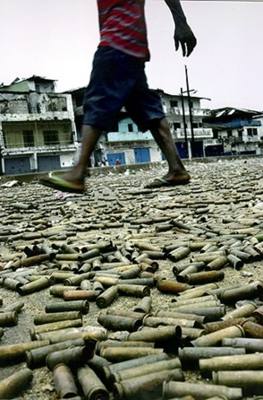 WAR UNDERFOOT: Bullet casings carpet a street in Monrovia, at the heart of the battlefield between government and rebel soldiers. Businesses closed for weeks as the battle raged. (Carolyn Cole)
