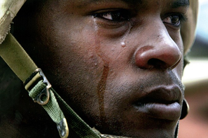 Squad leader and Staff Sgt. Lonnie Roberts stands at attention as troops from the 3rd Brigade Combat Team pay last respects to their fallen comrade, Pvt. Gregory Huxley, during a memorial for the 19-year-old in Baghdad. (David Leeson)