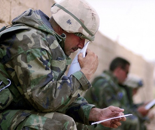 After three weeks and 300-plus miles of speed-and-maneuver warfare, Master Gunnery Sgt. Frank Cordero savors the first letters from his wife, Melissa. "I held that first one for about five minutes... Just to smell it and hold it." (Cheryl Diaz Meyer)