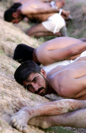 A pained stare, plastic ties and muddy, shoeless feet. In war, everyone is suspect. After a short firefight in Sayyid Muhammad, these men were rounded up, stripped, interrogated and later released. (Cheryl Diaz Meyer)