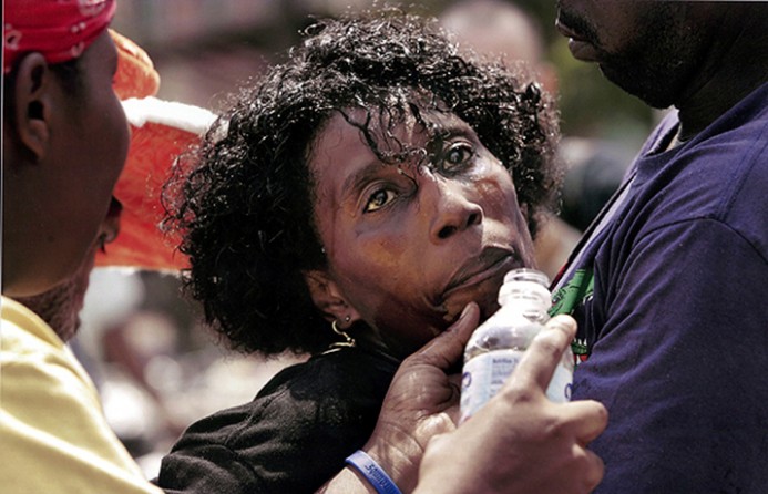 New Orleans, LA -- Friends gave 41-year-old Dana Clark a drink and moved her into the shade after she fainted outside Morial Convention Center. 