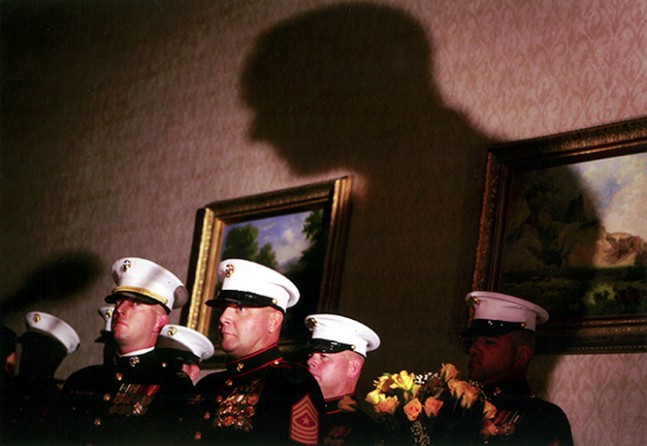 During the formal ceremony, called "Remembering the Brave," which was held at a Holiday Inn in Denver, Captain Chris Sutherland, left, Sergeant Major Jeff Study, Staff Sergeant Clifford Grimes and Gunnery Sergeant Todd Martin prepare to deliver posthumous medals to the families of fallen Marines. They also presented each family with a vase of yellow roses -- one rose for each year of the Marine's life.