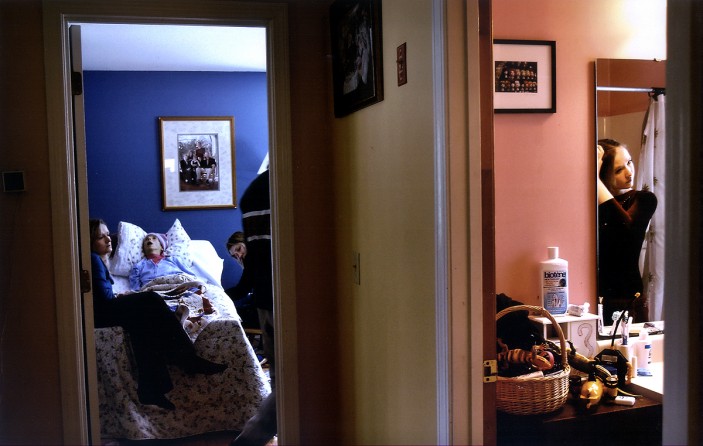 Melissa braids her hair while getting ready for her state gymnastics meet as family members sit with Carolynne. As her mother got sicker, Melissa spent less time at home. Fearing that Carolynne would die that day, Rich debated but decided to let Melissa continue with her plans. (2/13/07)