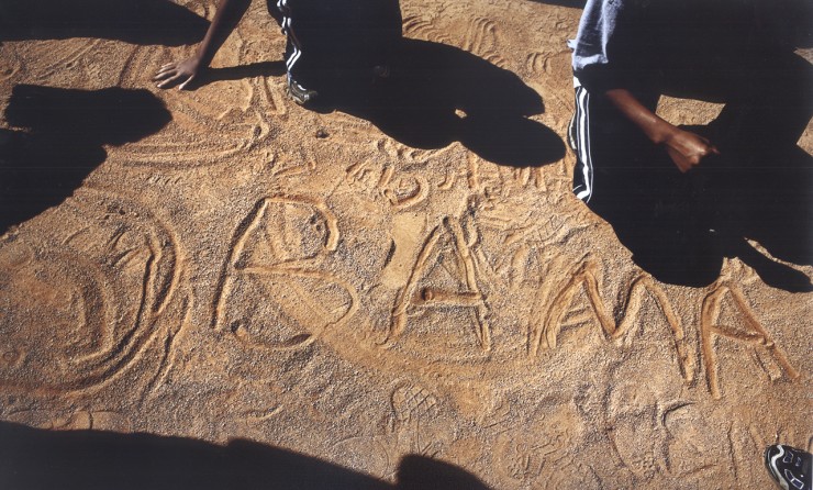 Children inscribe a favorite at an Obama rally at Ed Smith Stadium in Sarasota, Fla.