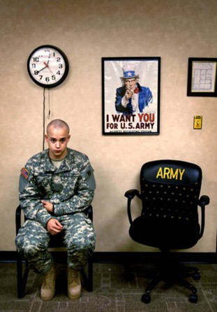 Ian Fisher cradles his injured elbow during his processing into the Army in Ft. Benning, Ga. On June 20, 2007. Though he later had a change of heart after speaking with a commander, he saw a possibility to escape his enlistment only two days in. From his first day in fatigues through his days driving a Humvee in Iraq, military life often didn’t mesh with his expectations. Sometimes the structure of the Army and the demands of training for war clashed with the freedom he shared with his outside friends. (Cra