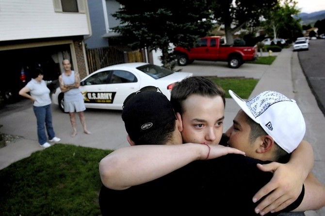 As Ian's father, Eric, waits in the driveway with the recruiter who's about to take Ian away to 14 weeks of basic training, Ian embraces friends Nick 'Buddha' Nelson, left, and Shane 'Pineapple' Doiel on June 17, 2007. Between hugs, Ian's eyes welled with tears.  Ian approached his father.  You got everything? Eric whispered.  Yeah, Ian replied.  The car pulled out, and Ian was gone.  As soon as we saw him driving off, that’s when we realized how real it was, 'Buddha' said. (Craig F. Walker, Denver Post - 2