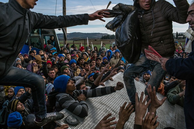 November 28, 2015. Refugees from Pakistan, Bangladesh, Morocco, Algeria and Somalia struggling for donations of water, blankets, diapers and some clothes on their 10th day encamped near the border in Idomeni, Greece. They were not allowed to cross into Macedonia; only refugees from Afghanistan, Iraq and Syria were allowed to cross and continue their journeys (Mauricio Lima, The New York Times - November 28, 2015). 