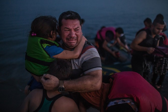 Laith Majid, an Iraqi, broke out in tears, holding his son and daughter after they arrived safely in Kos, Greece, on a flimsy rubber boat (Daniel Etter, The New York Times - August 15, 2015). 