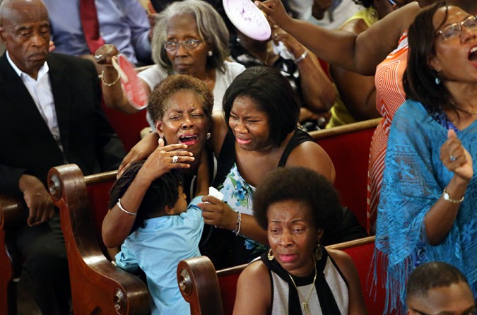 Grieving mourners fill the pews as Emanuel AME Church re-opens its doors for Sunday services four days after nine parishioners were slain by a white supremacist during a Bible study. The shooting occurred in the basement of the church, directly below the sanctuary where mourners are gathered for the Sunday service. (Paul Zoeller, The Post and Courier - July 21, 2015).