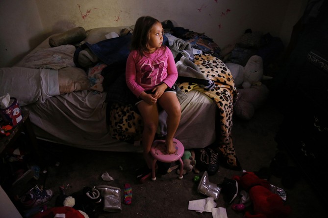Mimi escaped into her parents' room to watch television the night before her mother started treatment at a methadone clinic. The older of the two children, Mimi is silly but also sensitive and responsible, often helping Raquel with small things like pulling up the socks she can't reach, or swooping in with a hug when she can sense that her mom's mood is about to take a turn (Jessica Rinaldi, The Boston Globe).
