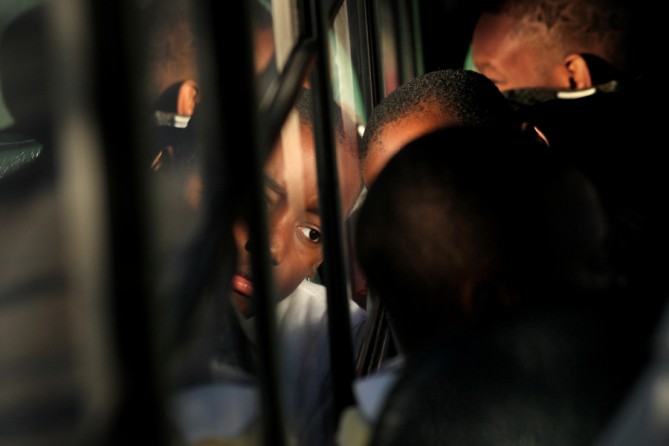 Fourth-grader Jasani Freeman gazes out the bus window as the class leaves for a field trip to see a performance of The Christmas Carol. Because the students come from impoverished families, many had never seen a theatrical production before, and were unsure of what to expect. (August 25, 2013)