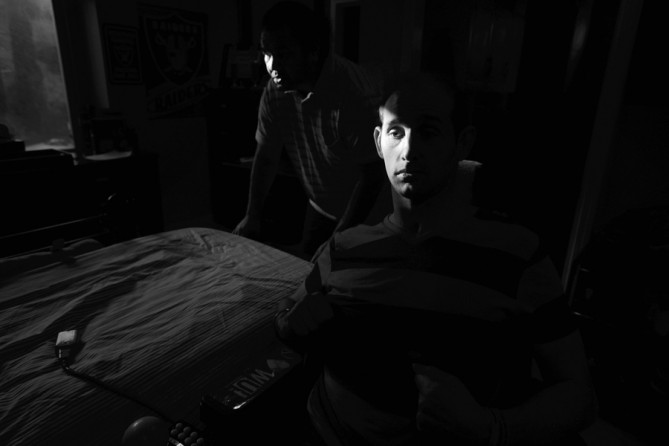 Aaron Rubin waits while a caregiver prepares his bed for an afternoon rest before dinner. (December 31, 2012)