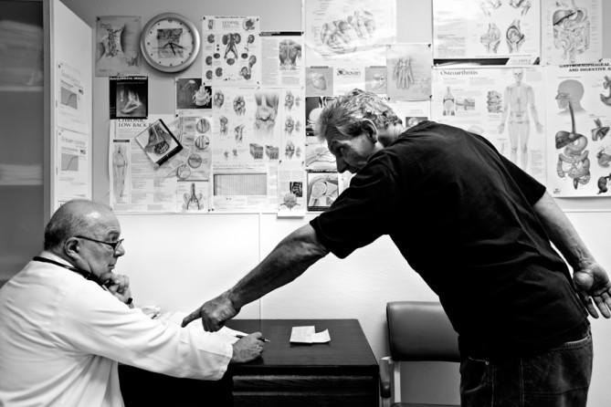 John Jackson, a former stuntman who broke his back on the job, meets with Dr. Julio Diaz during an appointment. (December 31, 2012)