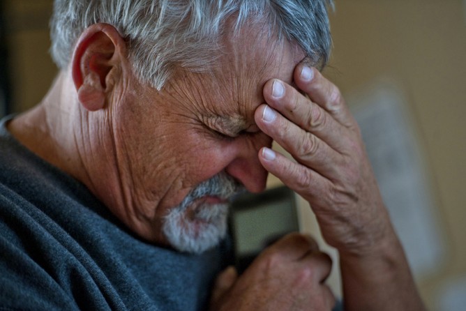 Don Hatfield checks to make sure a fax has been received as he coordinates healthcare insurance for his three grandchildren, Alex, 10 months, Ariel, 3, and Eva, 4. (April 6, 2012)