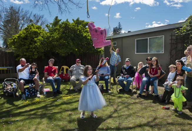 Eva Winkler celebrates her fifth birthday dressed as Wendy from Peter Pan as she tries to knock down a piñata.  (May 16, 2012)