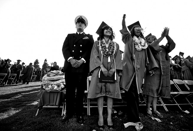 A wreath honoring slain student Dannie Farber Jr. is given a prominent seat at the Narbonne High graduation ceremony.  Farber, who played wide receiver on the schools football team, died after he was shot three times while eating dinner in Compton. He was three weeks from graduation when he was killed.  (Barbara Davidson, Los Angeles Times- December 29, 2010)