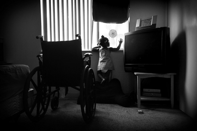 Miracle waves at her dad from the window. 'Without Miracle, I don’t know, I don’t know if I could have made it through.' 'She’s a warrior just like her mom.’  A bullet had just missed Miracle in the womb, and she was born addicted to her mother’s pain medication. (Barbara Davidson, Los Angeles Times)
