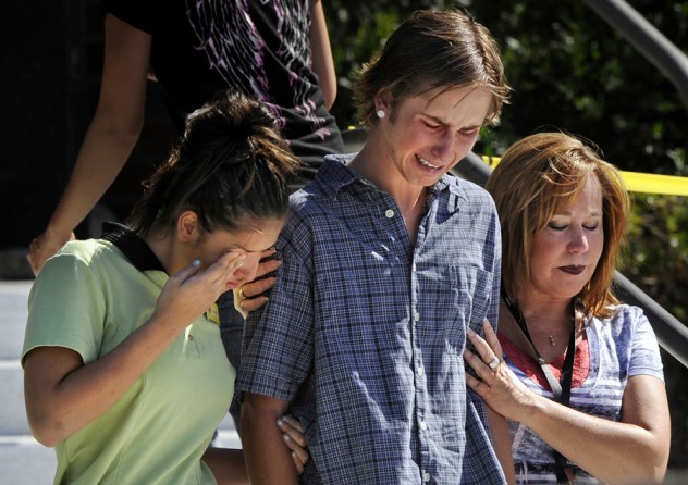Victims and witnesses leave Gateway High School after being picked up by friends and family members on July 20, 2012. (Craig F. Walker - July 20, 2012)