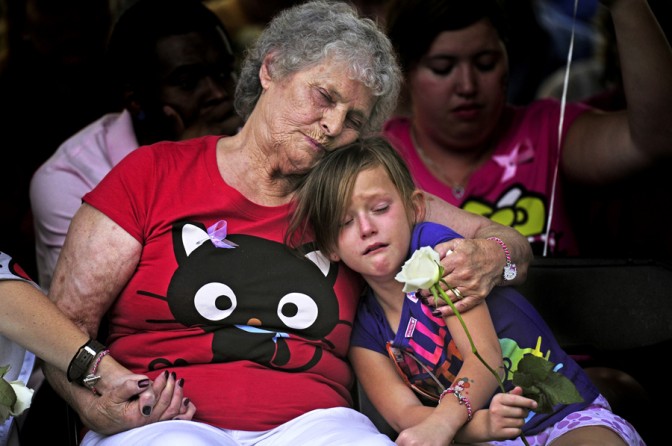 Marlene Knobbe, grandmother of Micayla Medek, killed in the movie theater shooting, consoles family member (Aaron Ontiveroz - July 23, 2012)