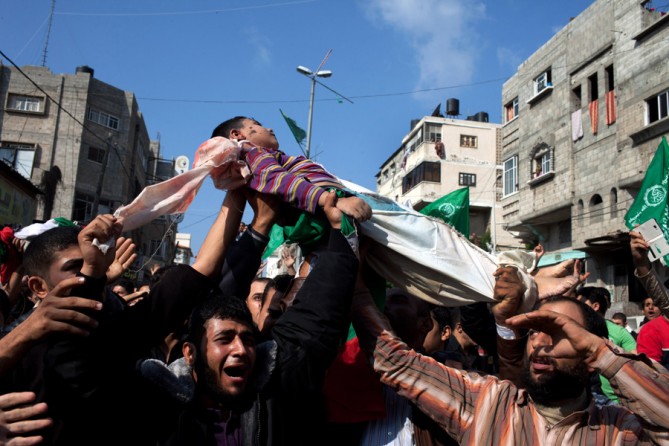 The body of a child being carried at the funeral for eight of the nine members of the Dalu family killed in an Israeli airstrike. (November 19, 2012)