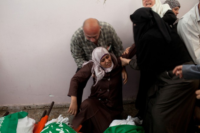 A mourner overwhelmed at the funeral. (November 19, 2012)