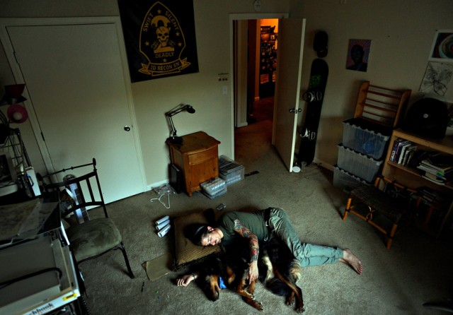 Scott lays on the floor with his dog, Jibby. He was exhausted and said, 'I'm tired of having bad f------ dreams. I can't take a nap because I'll feel worse. I fall asleep, but it doesn't make it better. Everybody says, 'With time, with time it will all go away.' So I'm waiting. He often credited his dog with saving his life. 'For me Jibby is very therapeutic. ... Sometimes I feel like a burden when I unload my emotions on friends, but Jibby's always there, regardless of what mood I'm in.' (Craig F. Walker, 