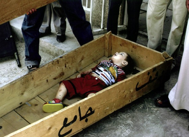 Baghdad - Mohammed Saleem, 18 months, lies in a coffin at a Sadr City morgue. Relatives said the boy and four other family members were killed in their car when U.S. forces opened fire overnight. 