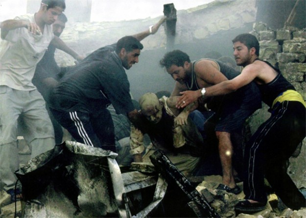 Baghdad - Iraqis rescue a man from the ruins of a building after a car bombing in central Baghdad. At least 10 people were killed, including three foreigners working to rebuild Iraqi power plants.