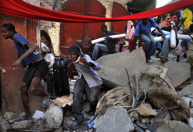 'Chaos'  Desperate Haitian survivors take goods from stores in the market area of Port-au-Prince as chaos erupts in the streets. The price of what few staples remain in the city had soared, fuel supplies had dwindled, and thousands of Haitians had abandoned listing homes for squalid tent cities springing up in even the smallest public spaces. Public parks and tennis courts filled with families carrying what possessions they had left. (Carol Guzy, The Washington Post - January 16, 2010)