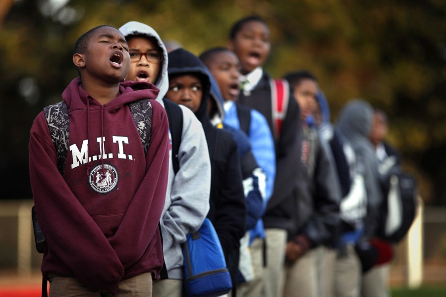 Imir Stills-Bey, left, Donavon Richard and Kavion Hammond lead Mr. Peter Wilson's sixth-grade class in the 'scholar holler' at the start of school. The chant is done every morning before class at the 100 Black Men Community Charter School to promote a eagerness for learning. (August 25, 2013)