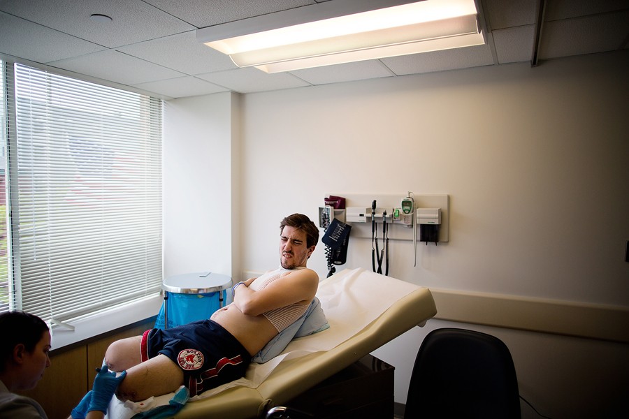 A month after the bombings, Bauman had the sutures removed from what was left of his legs at Boston Medical. Outside, a flag flew at half-staff in honor of the victims. (Josh Haner, The New York Times - May 15, 2013)