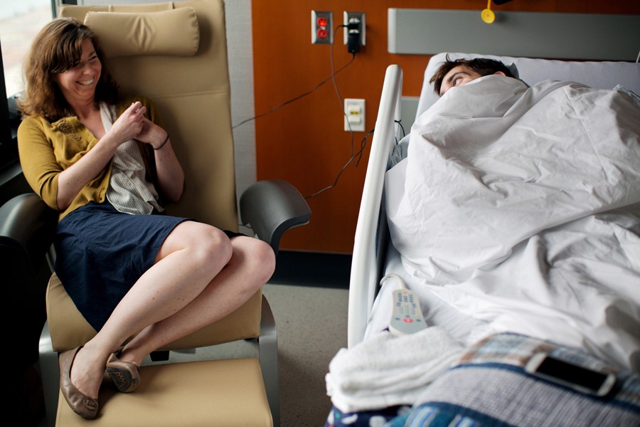Bauman shares a joke with his girlfriend Erin Hurley at Spaulding Rehabilitation Hospital.  He had been at the marathon finish line waiting for her to complete the race when the bombs went off. (Josh Haner, The New York Times - May 8, 2013)