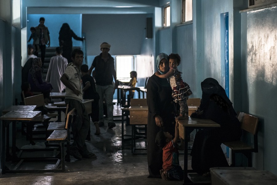 July 19, 2014. Displaced Palestinians take refuge at a school run by the United Nations in Rafah, Gaza. (Sergey Ponomarev for The New York Times)