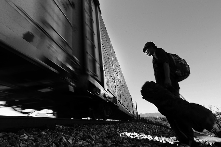 "Vladimir Rodriguez, 25, watches as a northbound train while waiting along the tracks in Saltillo, Mexico, Thursday, August 14, 2014. When asked why he didn't try to board it, he said, 'that one's going to Nuevo Laredo, too many problems with organize crime and I don't have the money to pay the bribes'. He was waiting on the train to Piedras Negras, on the border with Eagle Pass, Tx. (Jerry Lara/San Antonio Express-News)
