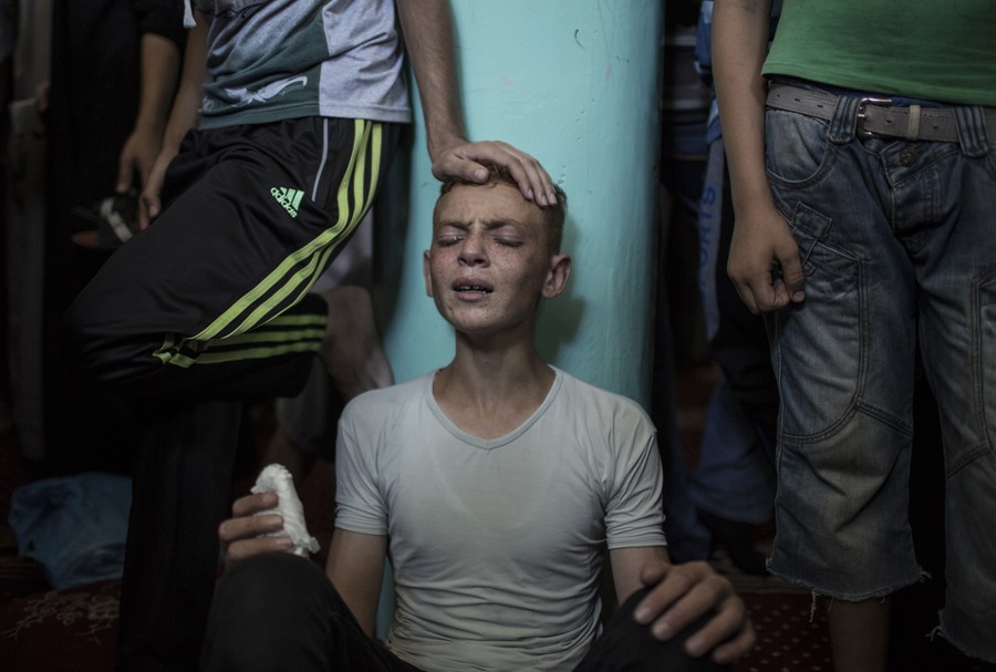 "Aug. 21, 2014. A relative mourns Raed al-Atar, one of three senior Hamas commanders killed in an Israeli military strike, during his funeral in the southern Gaza Strip town of Rafah. (Wissam Nassar for The New York Times)