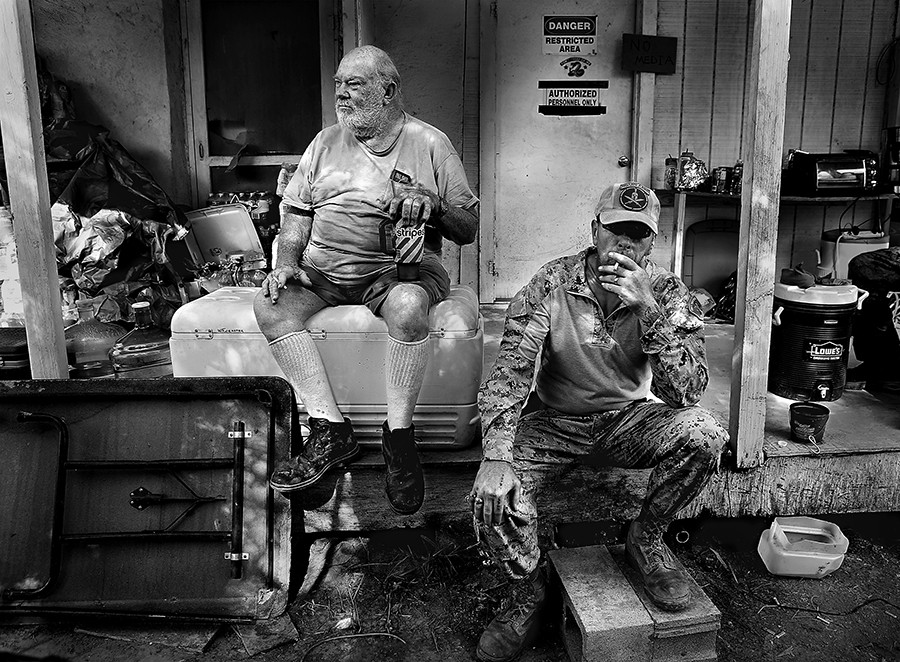 KC Massey, right, takes a drag on a cigarette as he sits with land owner Rusty Monsees Jr. Monsees asked the militia group called Camp Lone Star, to set up camp on his property along the Rio Grande River in Brownsville, TX. on Wednesday, September 10, 2014. Armed militias patrolled the border in South Texas searching for immigrants crossing the Rio Grande. Several militia members were later arrested on gun charges and outstanding warrants. (Bob Owen/San Antonio Express-News)