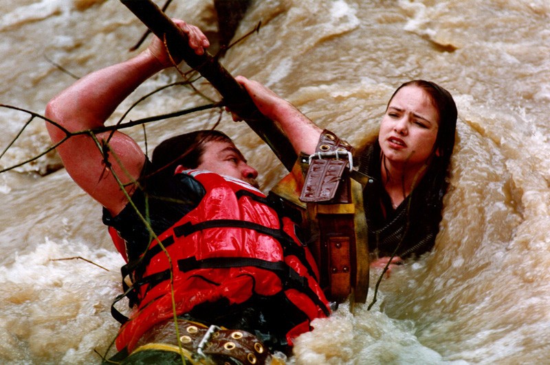 A local firefighter rescues a teenager from raging floodwaters.