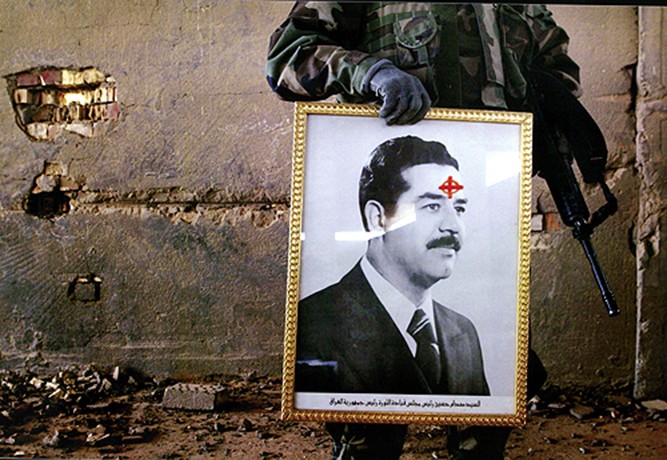 A bulls-eye drawn on a confiscated picture of Iraqi leader Saddam Hussein speaks volumes as U.S. troops from the 3rd Infantry Division clear out remanants from a building in Al Kifl. (David Leeson)