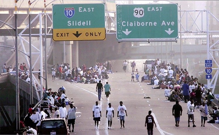 New Orleans, LA -- People wandered along Interstate 10 near the Superdome. Amid dire predictions, authorities decided to try to empty the city and move residents from the Superdome to shelters in Dallas and Houston in a two-day caravan of busses. 