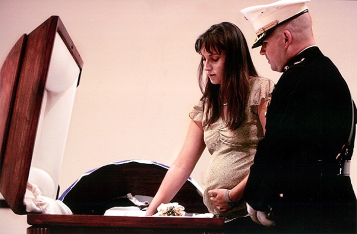 Since James Cathey was killed in a massive explosion, his body was delicately wrapped in a shroud by military morticians, then his Marine uniform was laid atop his body. Since Katherine Cathey decided not to view her husband's body, Maj. Steve Beck took her hand, and pressed it down on the uniform. "He's here," he said quietly. "Feel right here."